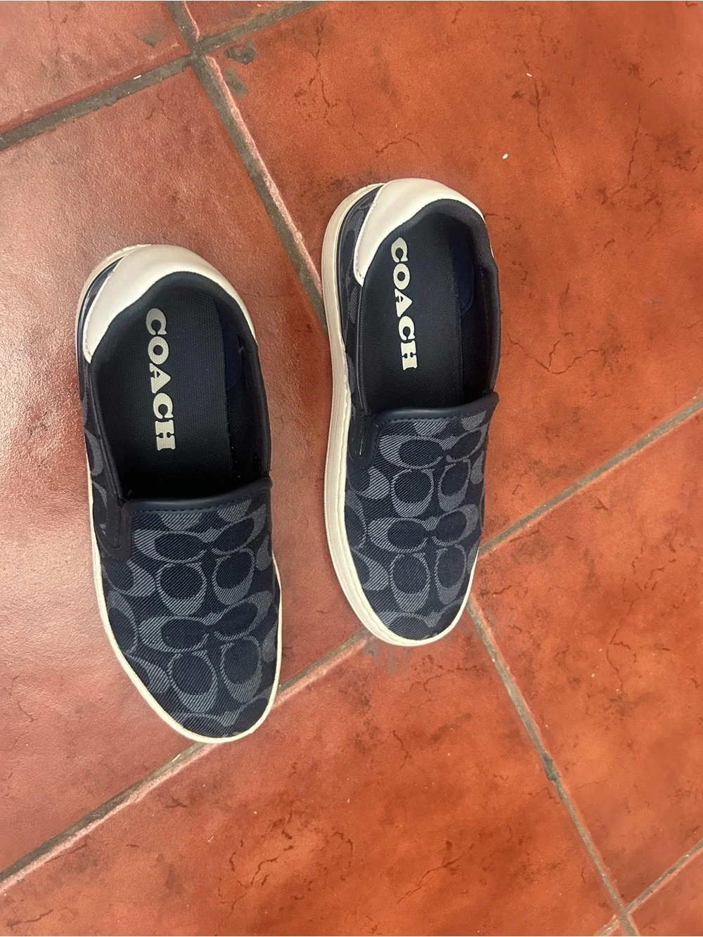 Coach women’s Black Navy Signature Slip-On Sneakers